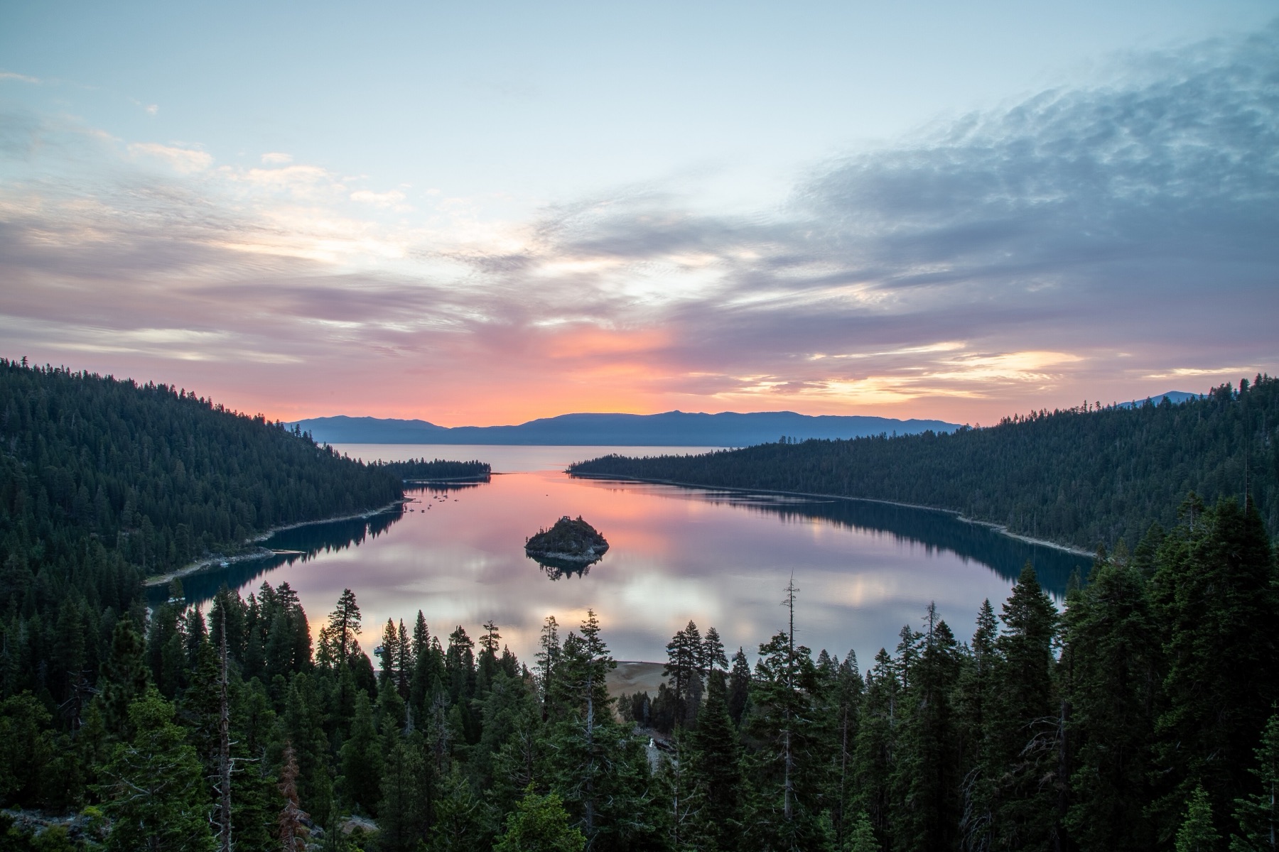 Emerald Bay on Lake Tahoe at sunset, ringed by pine forest